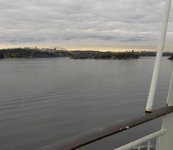 Photo taken from the cruise ship, looking at the bay, with calm waters, small-ish islands in the distance
