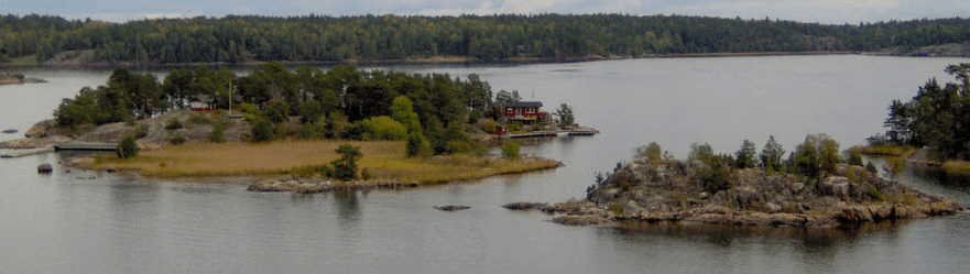 Little islands in the Stockholm bay, one stoney with some trees and the other more forested, with hones and docks on it