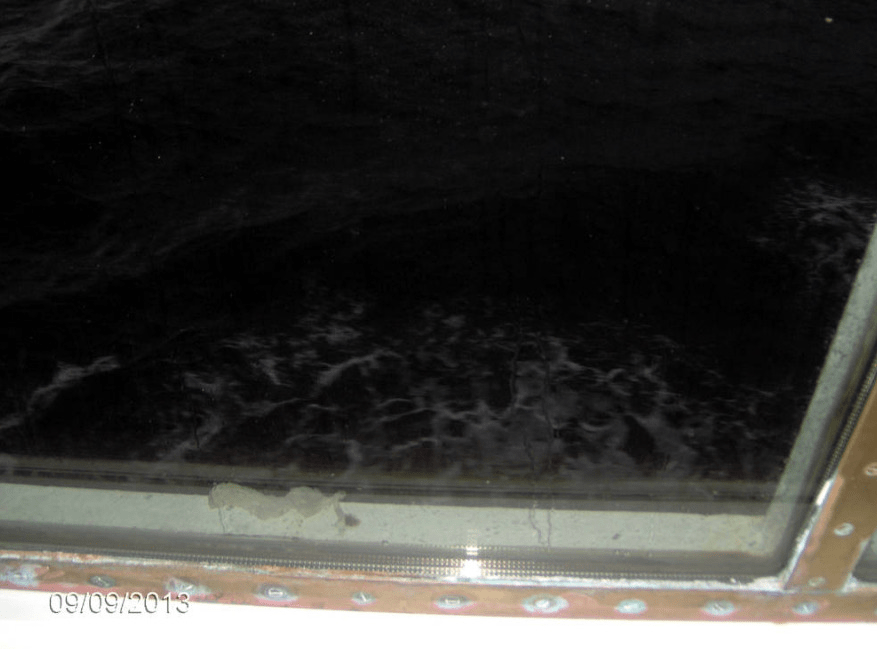 Photo from inside of the cruise ship Tallink, looking through the window at the black waters