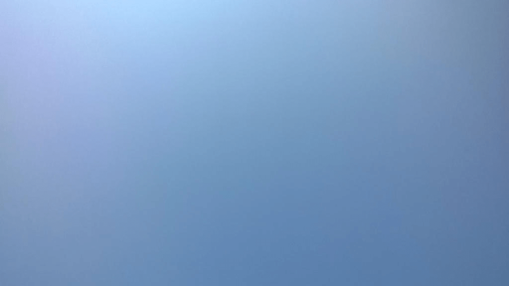 Perfectly clear blue skies, from pale blue in the upper left corner to darker blue in the bottom right corner