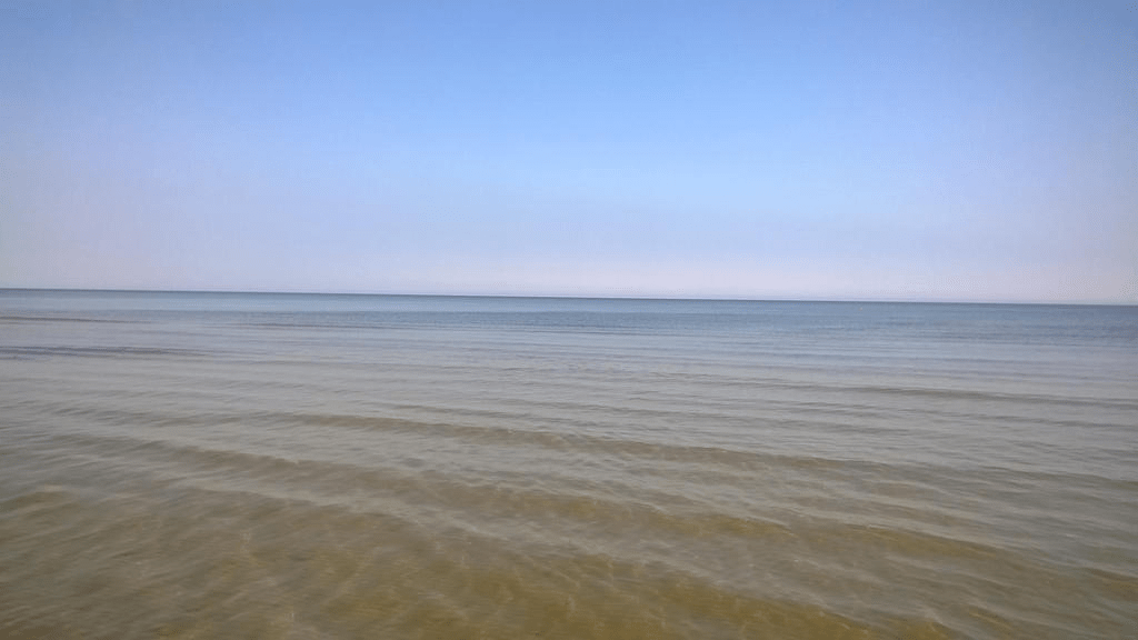 Shot of the Gulf of Riga, looking towards the horizon, the water calm and the sky perfectly clear