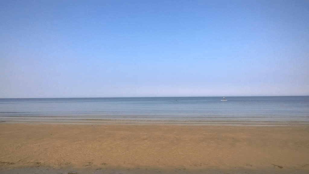 Photo of the Gulf of Riga, looking at the horizon, with a small boat in the distance