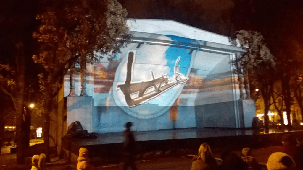 The faded painting of Riga fades in and a photo of remains of an old boat from the first settlers of the area