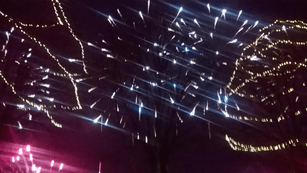 Blue and red fireworks popping in the sky