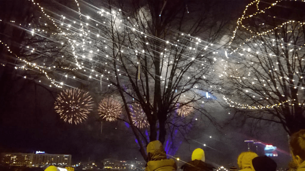 Bright and golden fireworks popping in the sky