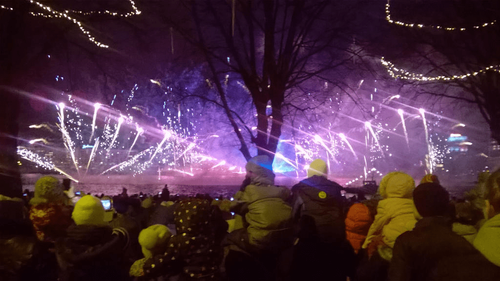 Purple smoke and bright lights shooting from the ground