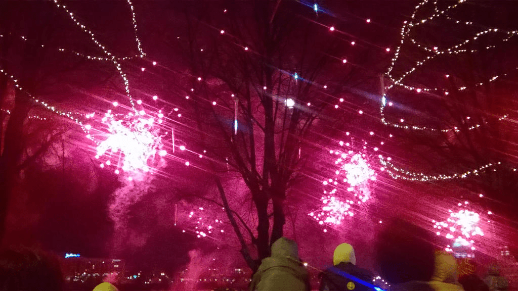 Clusters of red fireworks lighting up the sky