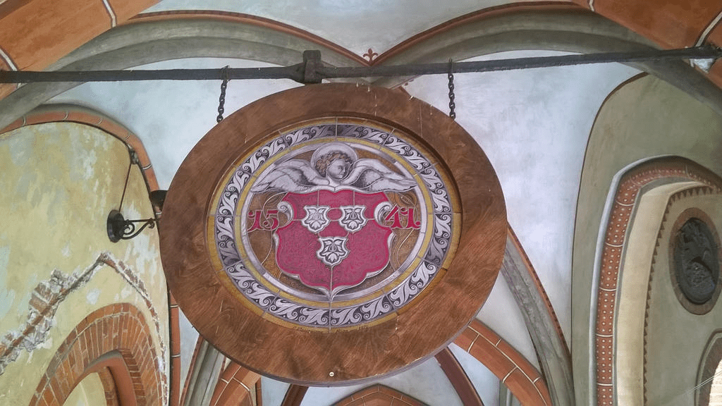 A big coat of arms hanging from the ceiling