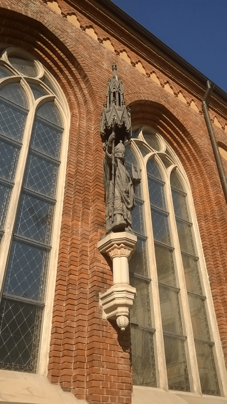 Statue of an Archbishop, holding a staff with the top looking like a church