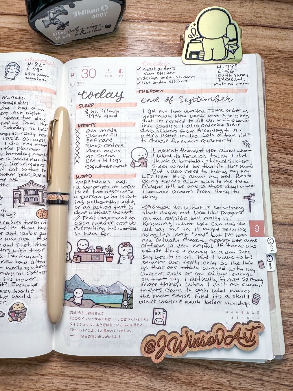 A planner open to a page dated September 30, featuring handwritten notes, tasks, and habits. It includes doodles of characters, a landscape, and various icons. A pen rests on the planner, and a bottle of ink is positioned above it.