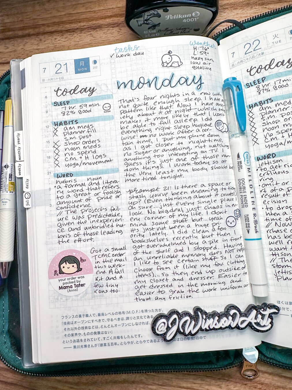 Hobonichi daily journaling page for July 21, 2025. Has light blue brush lettering and  stickers by TheCoffeeMonsterzCo on the page. In a dark green POTR zip case.