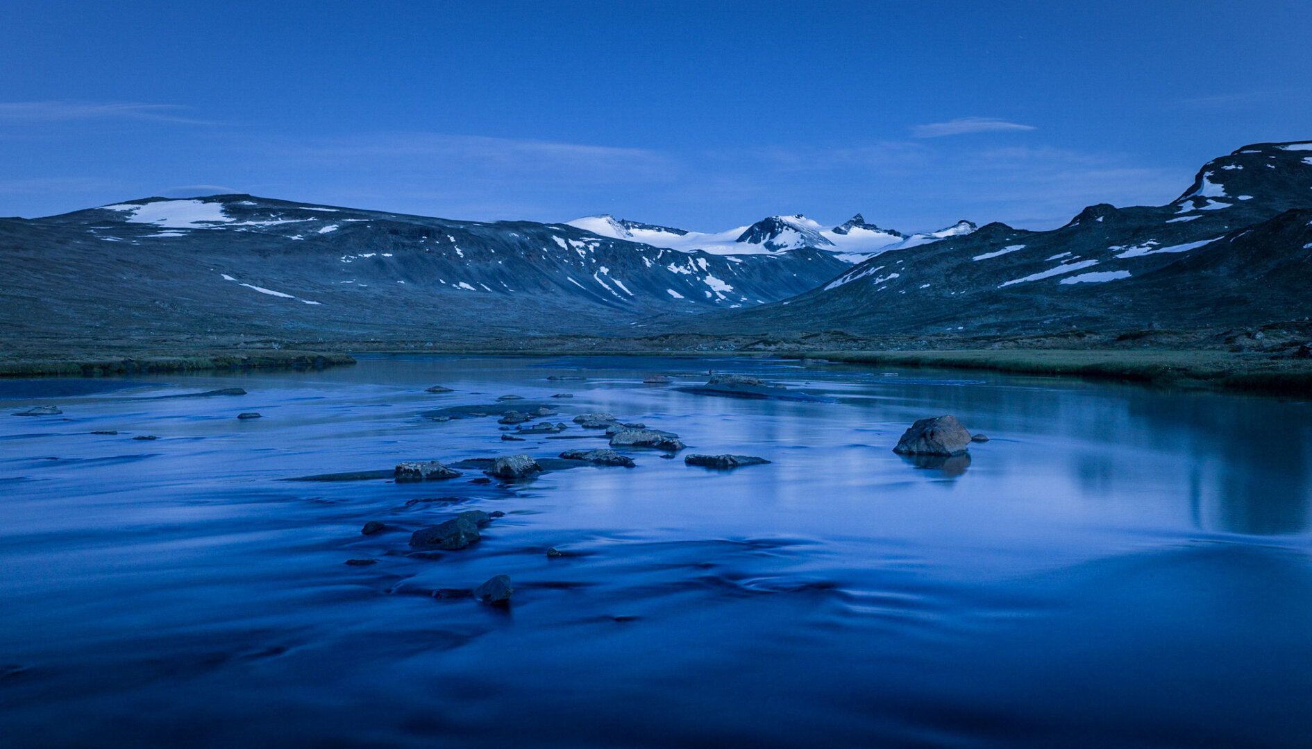A river in the mountains at midnight.