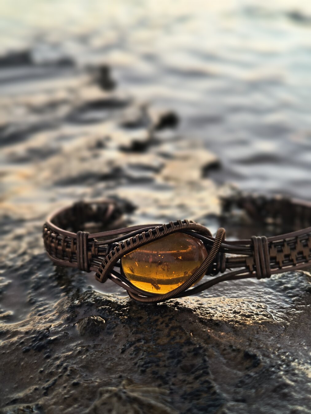 Chapter 7 — The Sea Tried to Claim It

🌊 Golden amber wrapped in copper — a little sun caught in a tidepool.

Getting this shot wasn’t easy. I waded in just far enough for the water to kiss the rock, waiting for the right shimmer of light… and for the waves not to steal my work.
A few times the ocean almost won.

But in the end, we caught it — still warm from the last rays of the day, glowing like it was lit from within.

#WireWrapping #AmberJewelry #OceanPhotoshoot #MalikasRealm