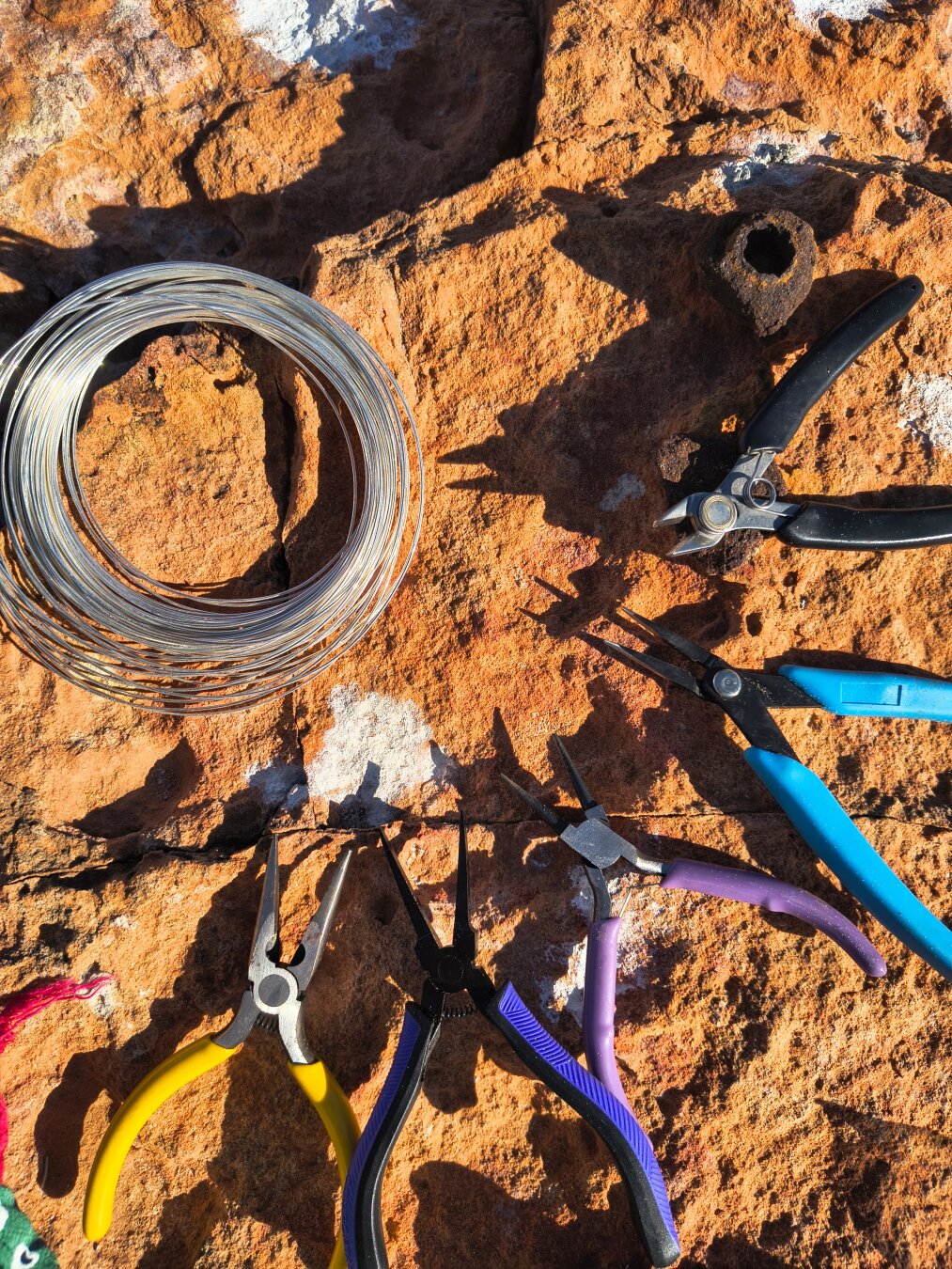 Chapter 9 — The Weight I Carry

🛠 Every piece you’ve seen starts here — wire, pliers, and a handful of tools worn smooth from use.

Right now, they travel with me in a backpack… along with stones I’ve collected, spools of wire, and even a small hammer.
It’s getting heavy, sure — but this is the weight of my craft.

Some people carry souvenirs. I carry the means to make them.

#WireWrapping #HandmadeJewelry #TravelArtist #MalikasRealm #Madewithsoul #Tools