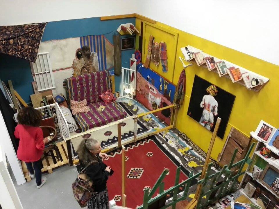 The installation work in collaboration with artist Helen Hintjes. Carpets on the floor with Yellow and blue walls. you get a birds eye view of us working on the installation before opening time.
