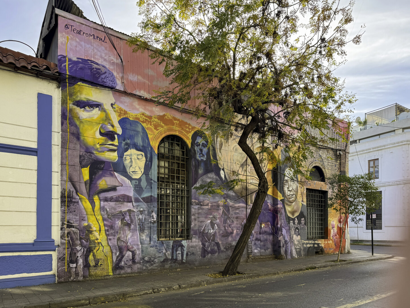 Small brick building with large colorful mural