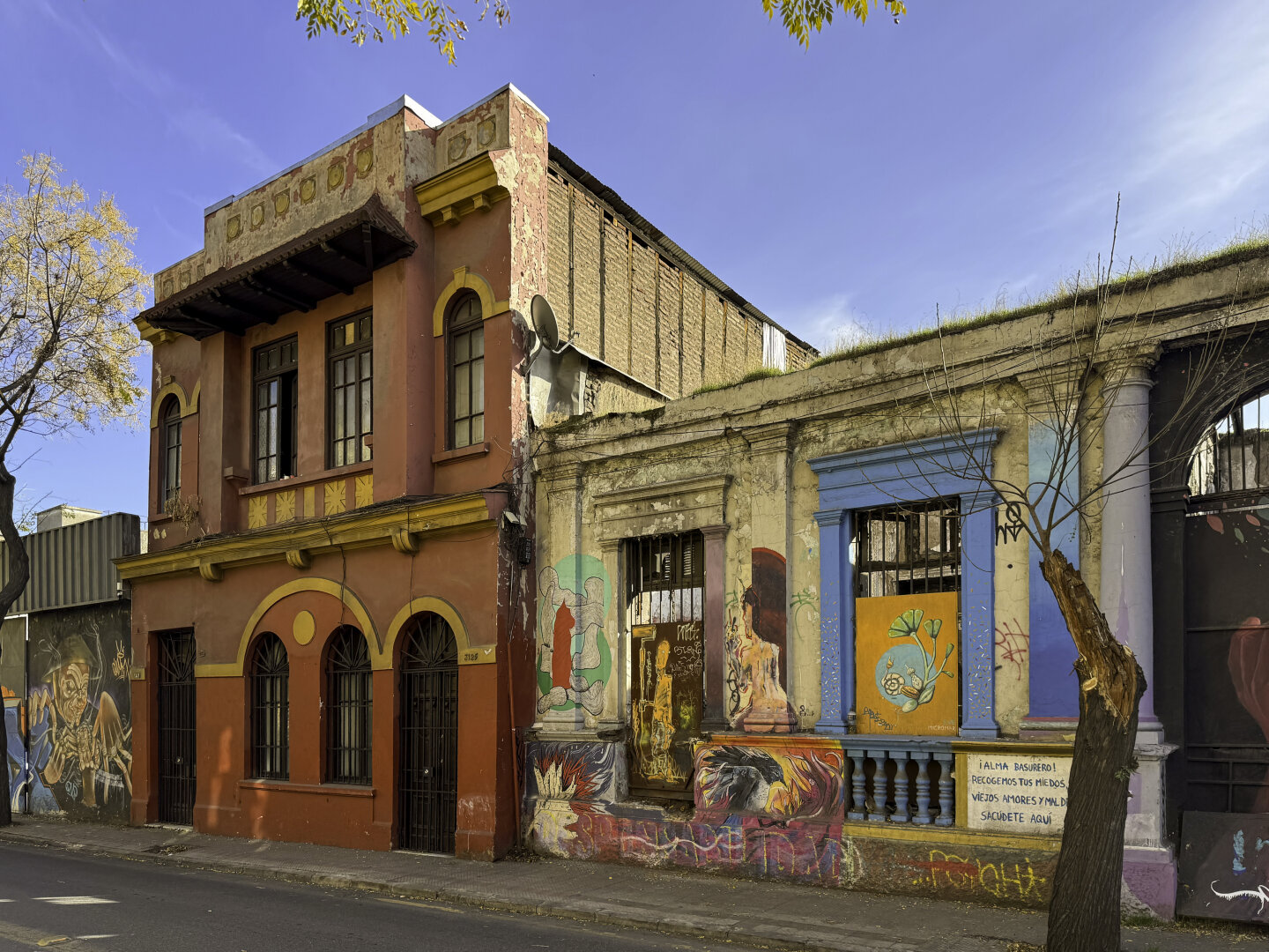 Low-scale buildings covered in colorful paint and street art