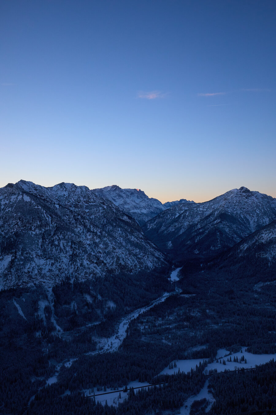 A snowy valley photographed from ontop of a mountain.