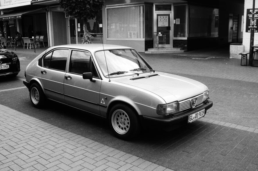 A silver 4 door fastback car