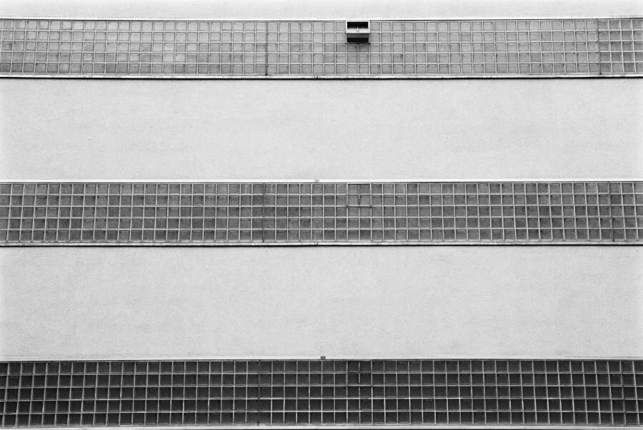An exterior wall with three long rows of glass bricks.