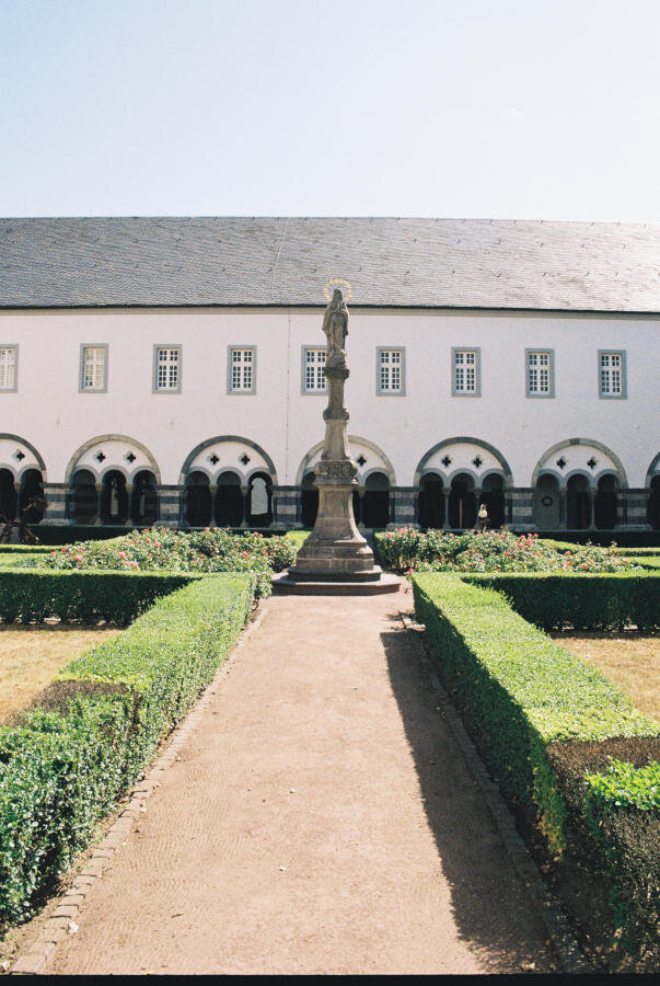 View of the east range of the cloister with a Marian statue