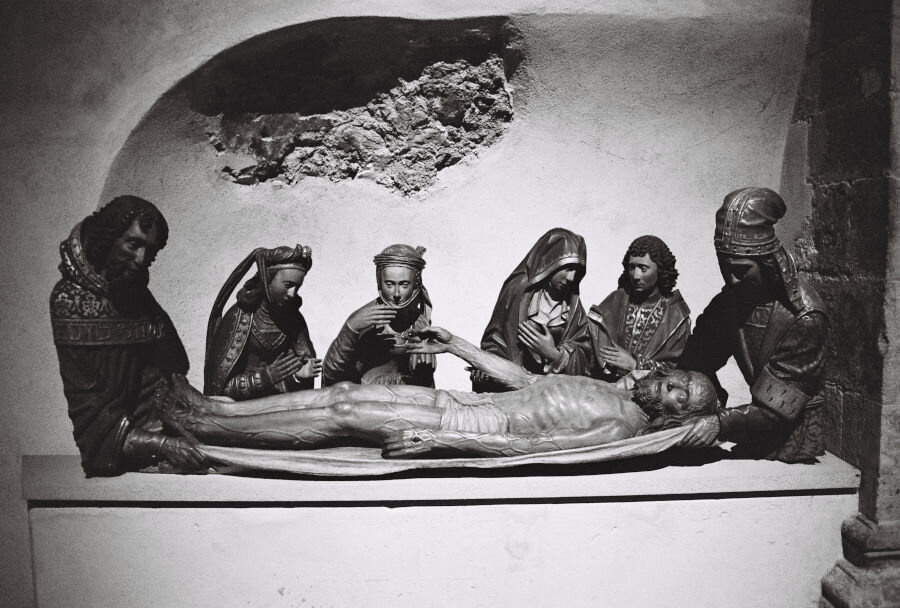 A sculpture group showing the friends and family mourning the dead Christ, laying hm in the grave. The figures are rendered with lifelike detail and sensitivity.