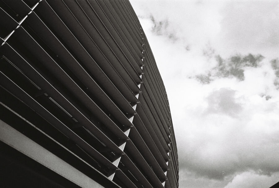A building with louvered windows looms overhead like a flying saucer.
