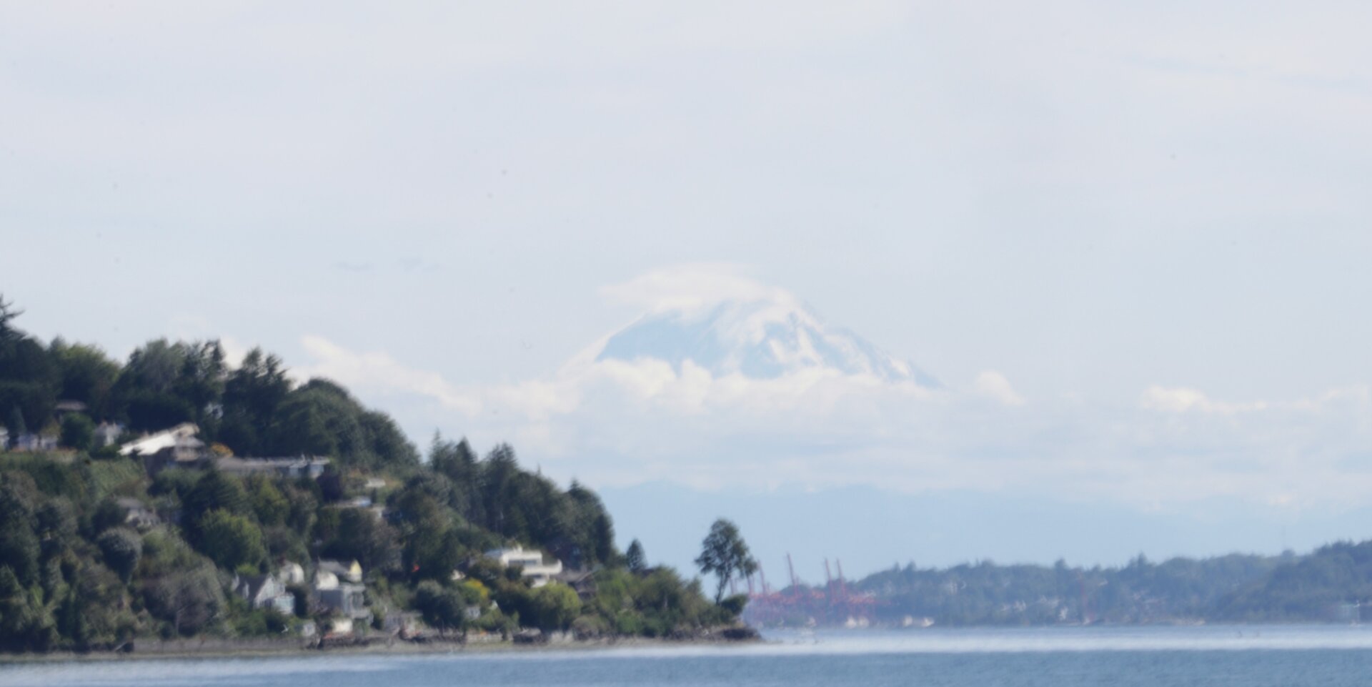 Mount Rainier peeks out from between the clouds