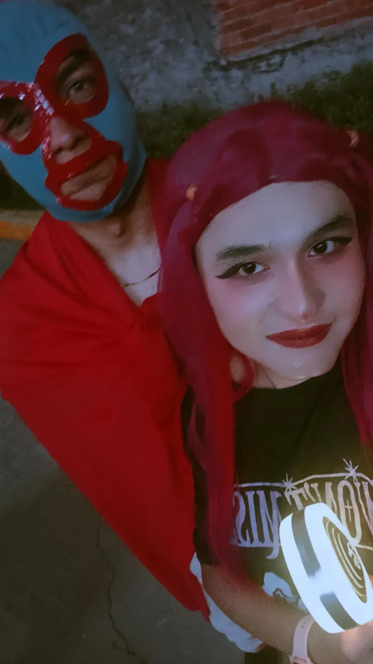 A selfie cosplaying Mira with a friend with a luchador costume.