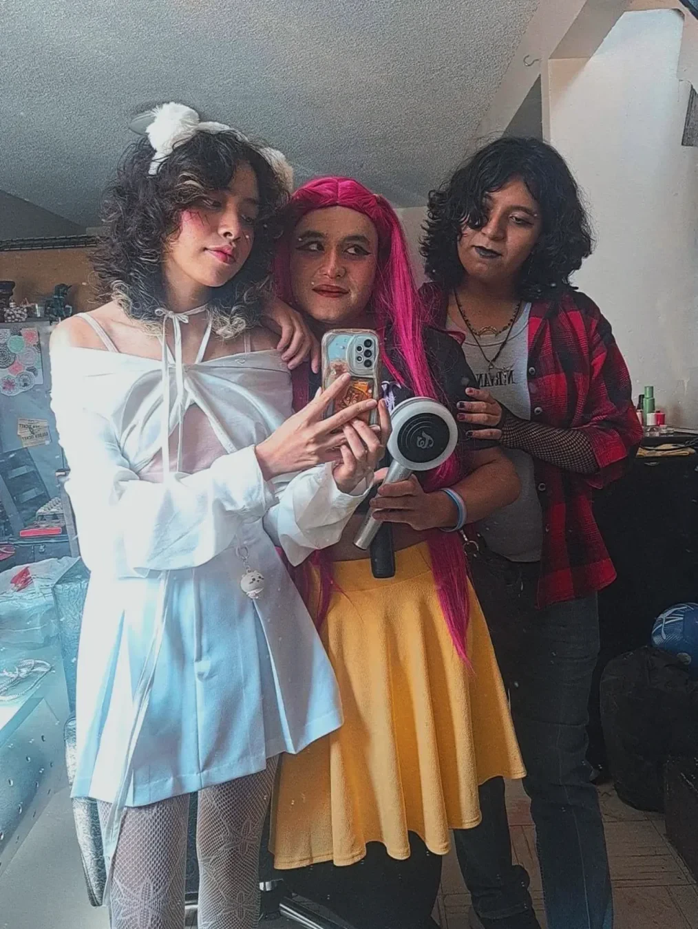 A mirror selfie with my friends, same cosplays as the previous picture.
