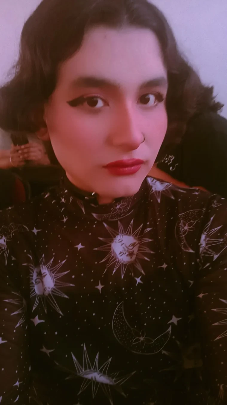 A selfie wearing a witchy star moon blouse.