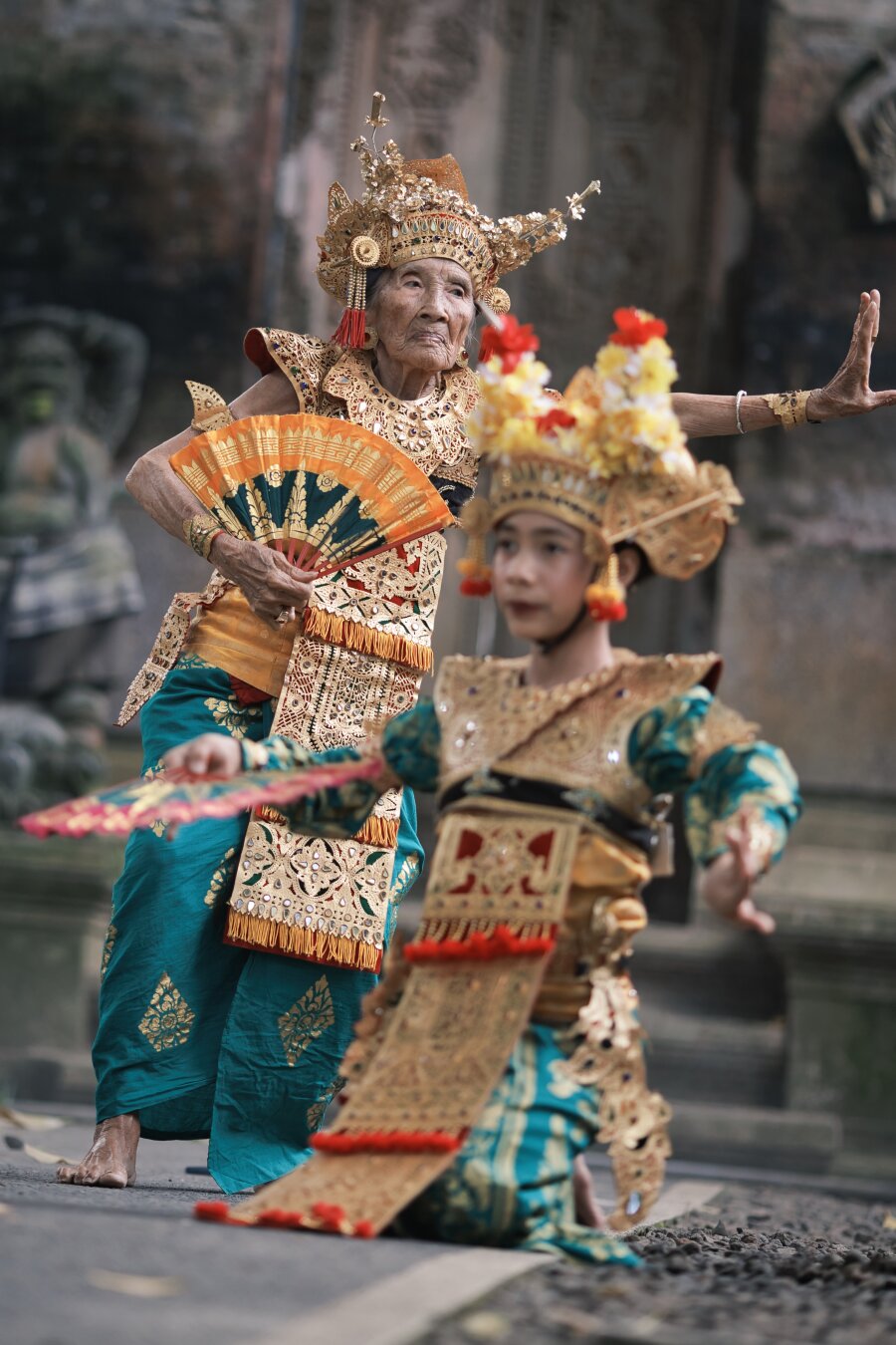 Full body portrait of Niang in action with the young dancer blurred in the foreground