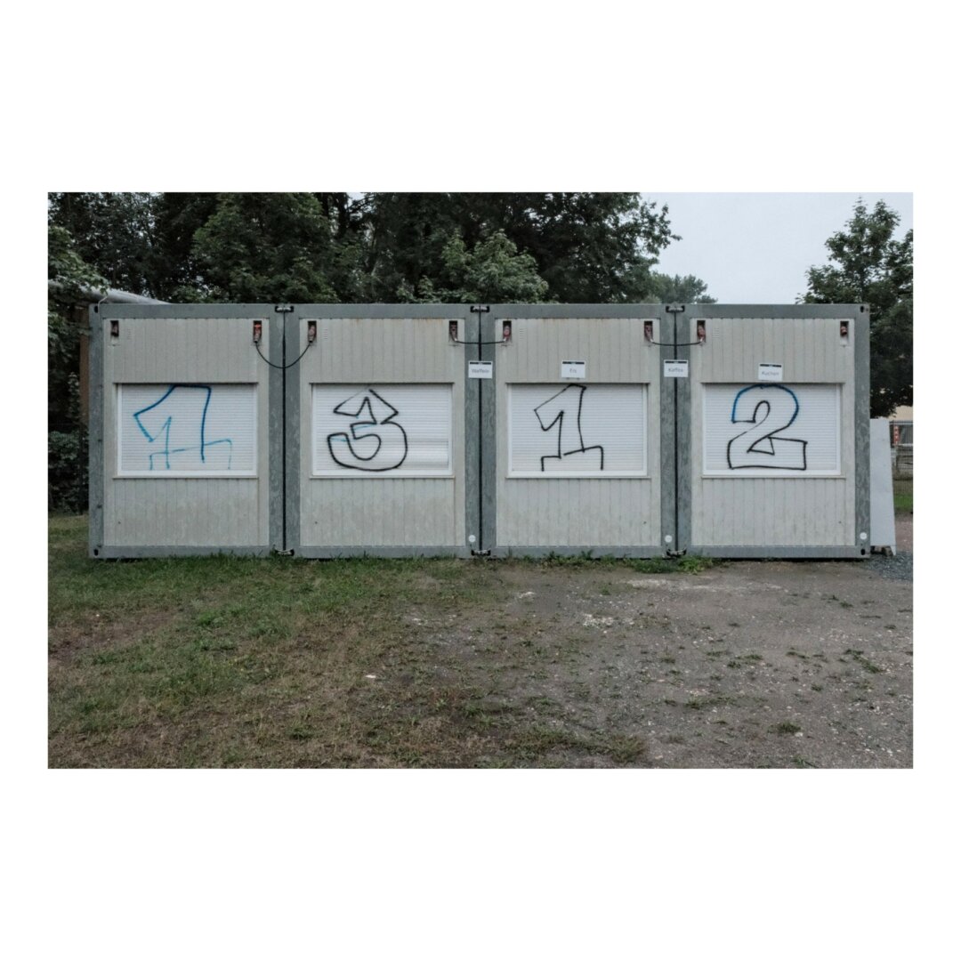 4 containers that display a 1312 graffiti.