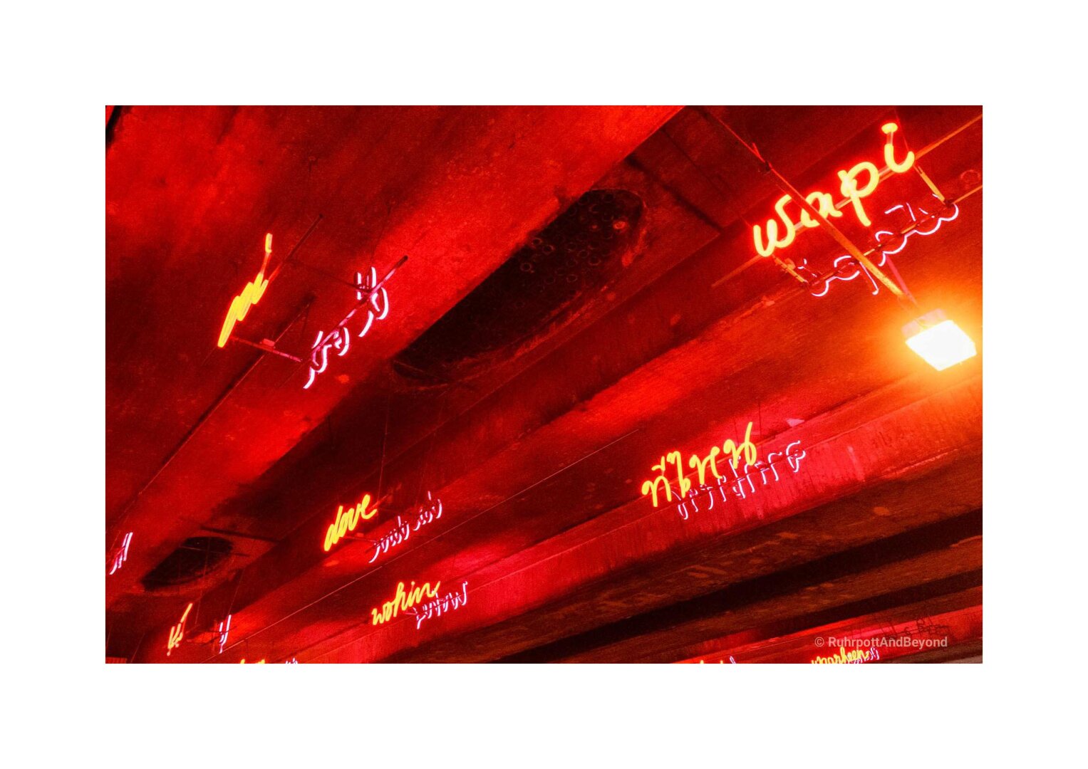 "Where From / Where To" in 15 languages. Neon art installation in an underpass in Bochum
