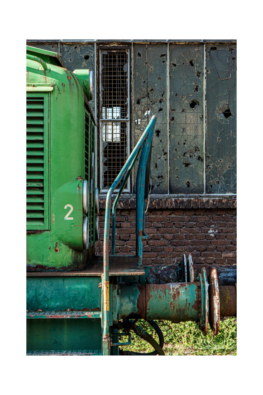 View of a locomotive, with a broken window in the background.