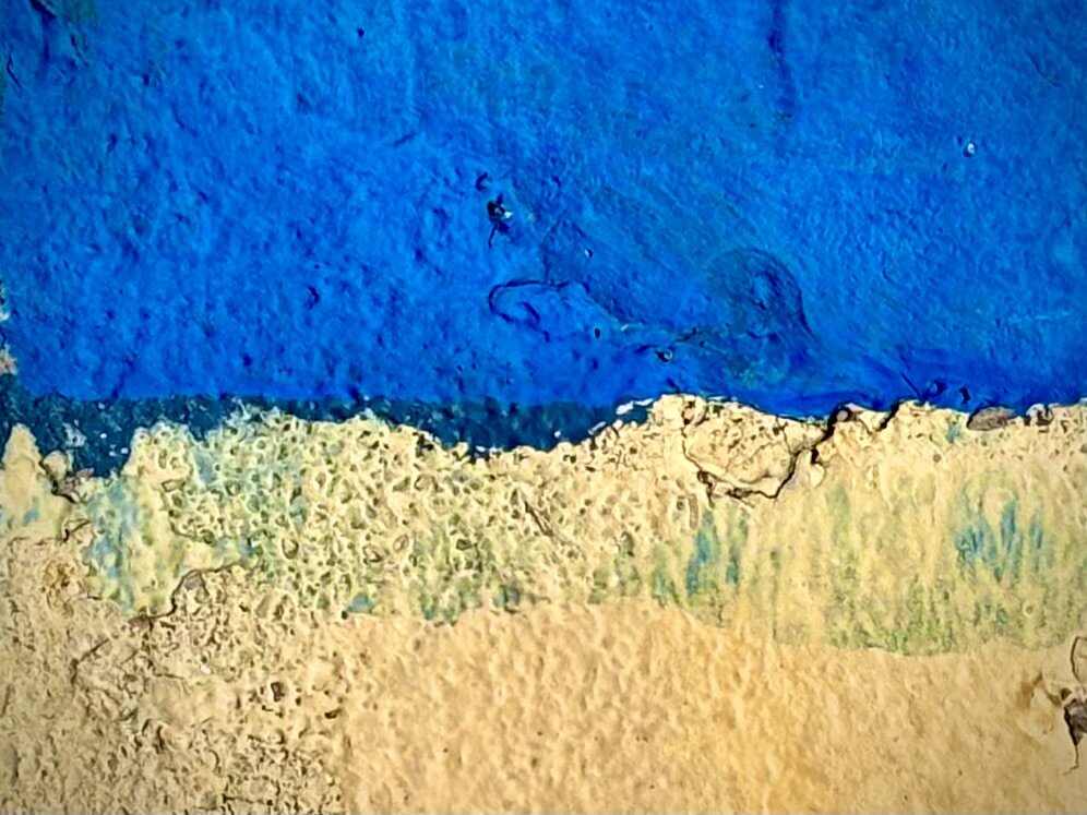 Blue and yellow paint overlap on a curb, cropped to look like the Ukrainian flag.